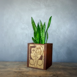 Kwadratowa osłonka loft w efekcie kortenu z ręcznie malowaną, złotą geometryczną twarzą.